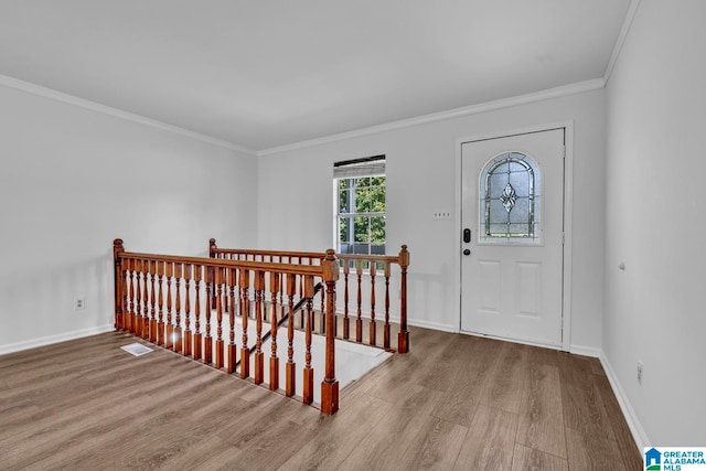 foyer with light wood-type flooring and ornamental molding