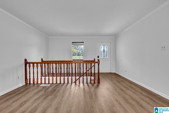 spare room with light hardwood / wood-style flooring and crown molding