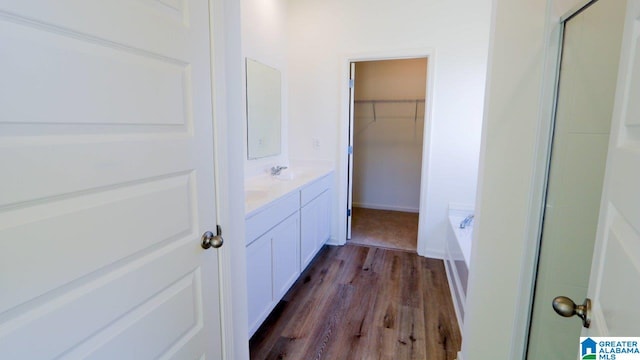 bathroom featuring separate shower and tub, vanity, and hardwood / wood-style flooring