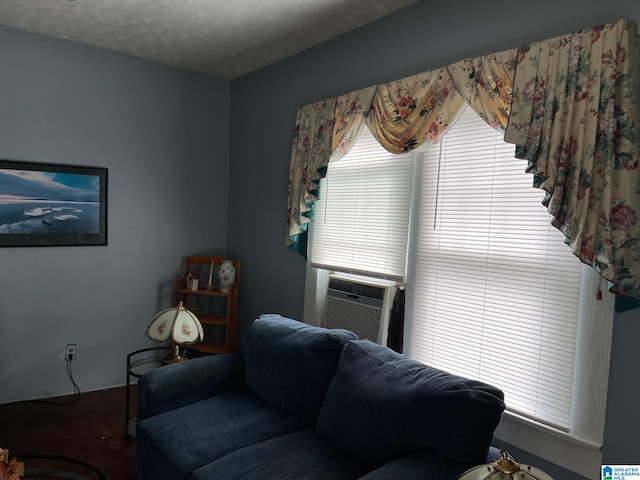 living room featuring cooling unit and a textured ceiling