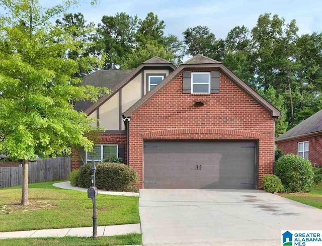 view of front of property featuring a front yard and a garage