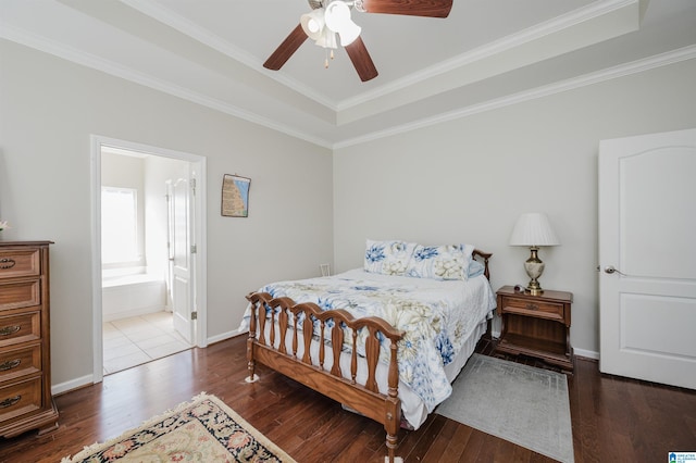 bedroom featuring ceiling fan, dark wood-type flooring, and ensuite bath