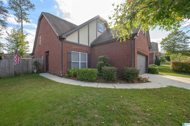 view of side of property with a garage and a lawn