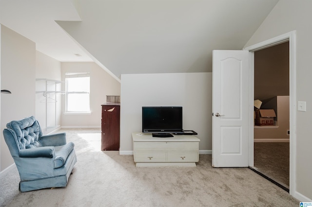 sitting room featuring light carpet and lofted ceiling