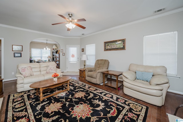 living room featuring ceiling fan with notable chandelier, dark hardwood / wood-style flooring, and ornamental molding