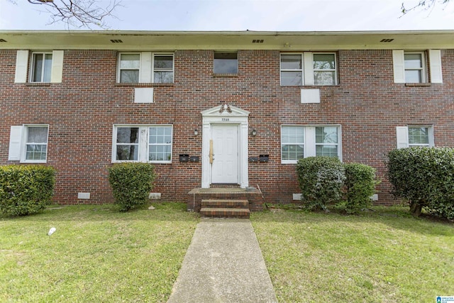 7749 5th Ave, Birmingham, AL 35206 - view of front of property featuring a front yard, brick siding, and crawl space