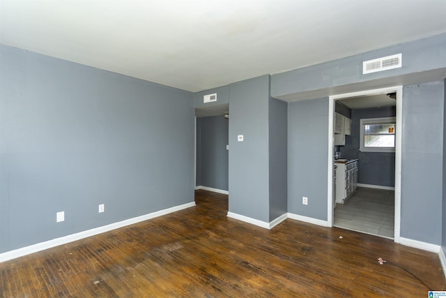 7749 5th Ave, Birmingham, AL 35206 - empty room with baseboards and dark wood-style flooring
