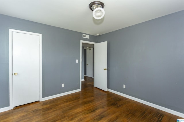 7749 5th Ave, Birmingham, AL 35206 - unfurnished bedroom with wood finished floors and baseboards