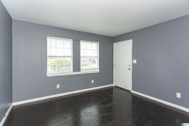 7749 5th Ave, Birmingham, AL 35206 - unfurnished room featuring baseboards and dark wood-style flooring