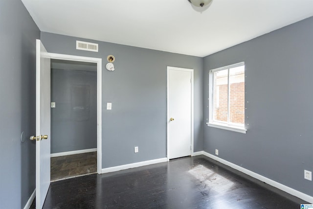 7749 5th Ave, Birmingham, AL 35206 - unfurnished bedroom with wood finished floors and baseboards