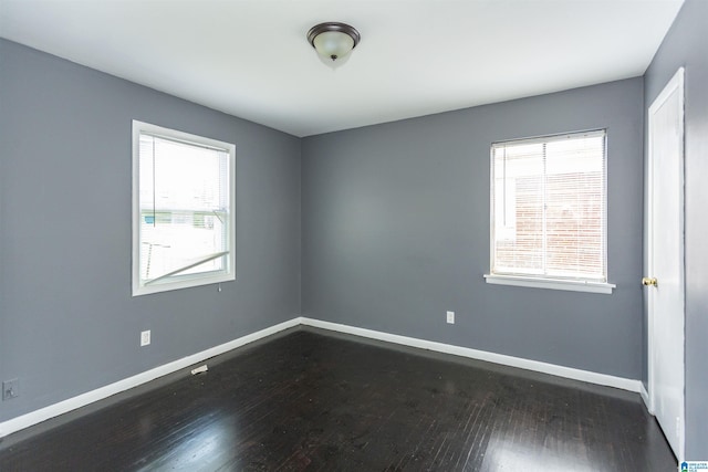 7749 5th Ave, Birmingham, AL 35206 - empty room featuring dark wood-style flooring and baseboards