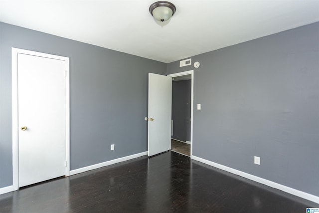 7749 5th Ave, Birmingham, AL 35206 - unfurnished bedroom featuring baseboards and wood finished floors