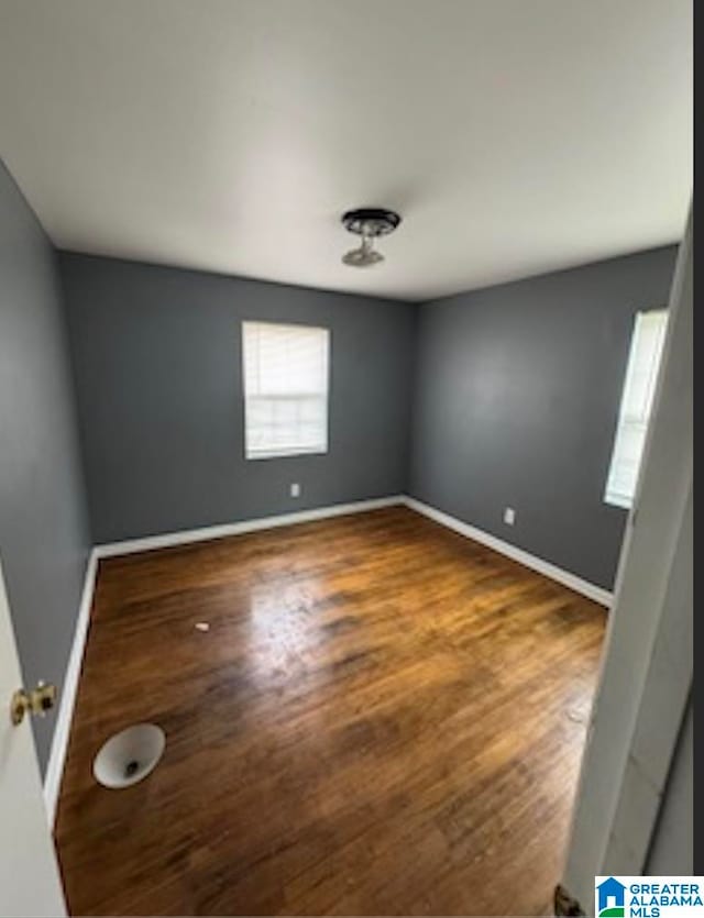 spare room featuring dark hardwood / wood-style floors