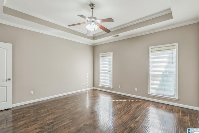 unfurnished room featuring ceiling fan, a raised ceiling, visible vents, ornamental molding, and hardwood / wood-style flooring
