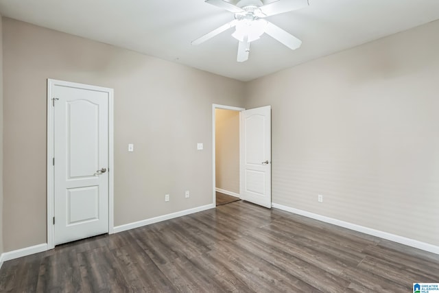 unfurnished bedroom with ceiling fan and dark hardwood / wood-style flooring