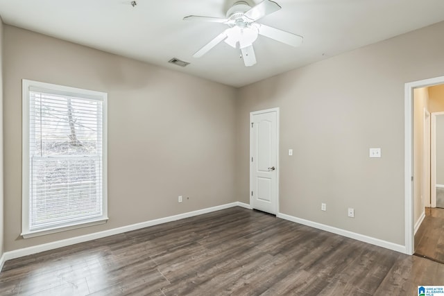 spare room featuring dark hardwood / wood-style flooring and ceiling fan