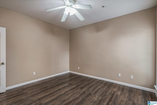 spare room with dark wood-type flooring and ceiling fan