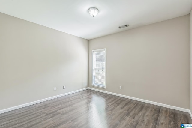 unfurnished room with hardwood / wood-style flooring