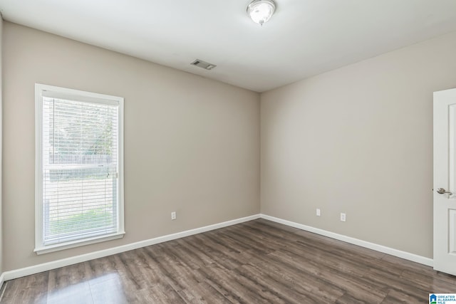 unfurnished room with dark hardwood / wood-style flooring