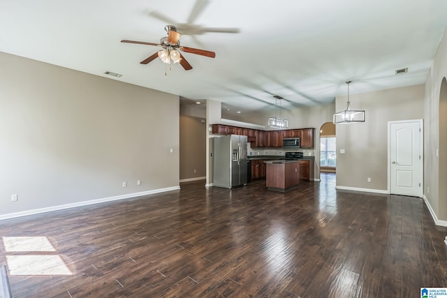 unfurnished living room featuring dark wood-type flooring and ceiling fan