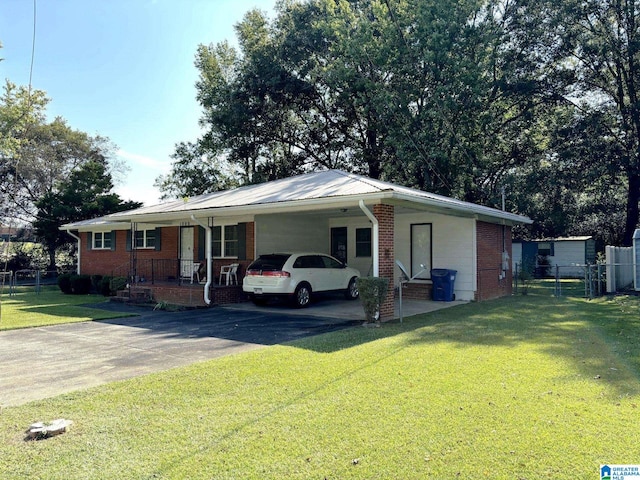 ranch-style house featuring a front lawn and a carport