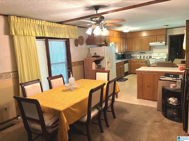 dining room with a textured ceiling and ceiling fan