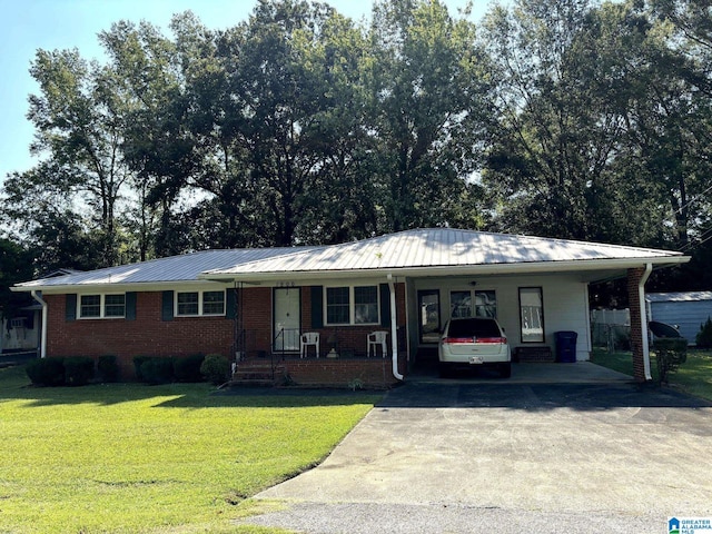 single story home featuring a carport, a front lawn, brick siding, and concrete driveway
