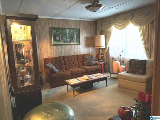 carpeted living room with ornamental molding