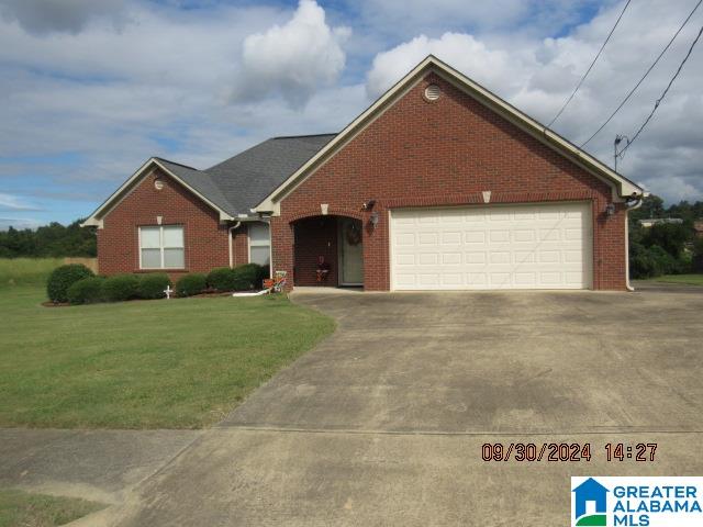 view of front of house with a front yard and a garage