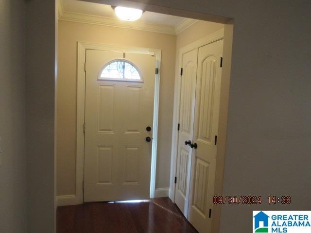 doorway featuring crown molding and hardwood / wood-style floors