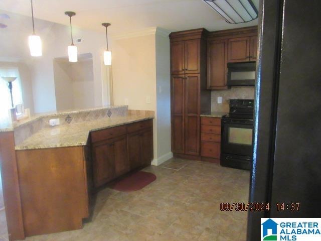 kitchen featuring black appliances, kitchen peninsula, decorative light fixtures, and tasteful backsplash