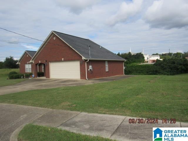 view of home's exterior with a garage and a yard