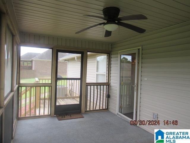 unfurnished sunroom with wood ceiling and ceiling fan