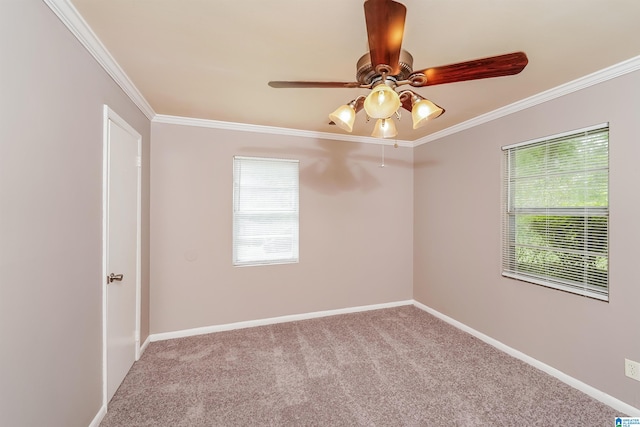 spare room with crown molding, light carpet, and ceiling fan