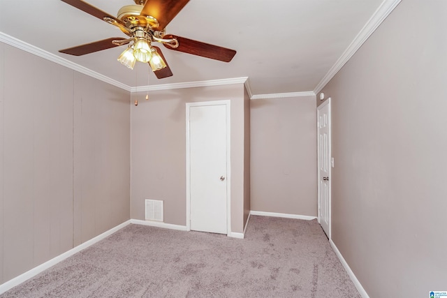 interior space featuring ceiling fan, light colored carpet, and crown molding