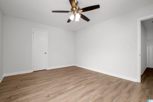 unfurnished room featuring light hardwood / wood-style floors, ceiling fan, and crown molding