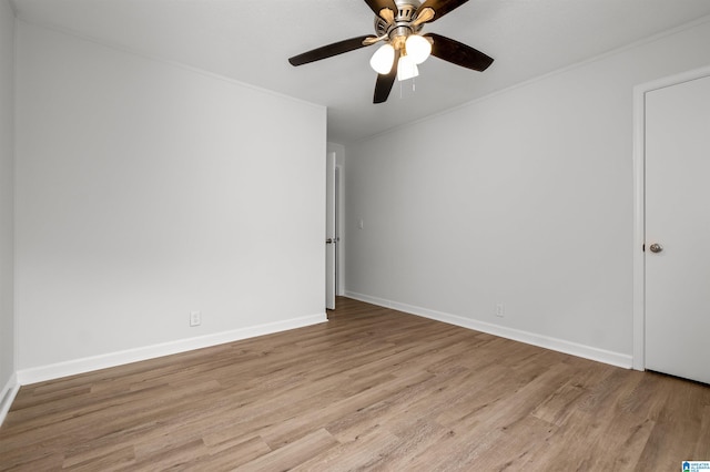 empty room with light hardwood / wood-style flooring, ceiling fan, and ornamental molding