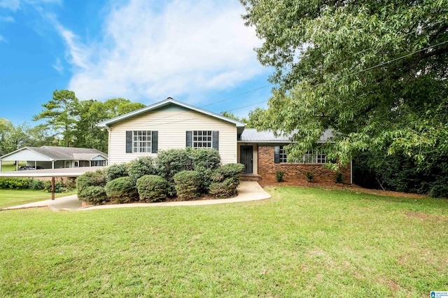 split level home featuring a front lawn and a carport