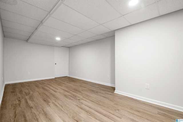 unfurnished room featuring a drop ceiling and light hardwood / wood-style flooring