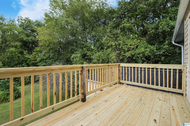 wooden deck featuring a yard