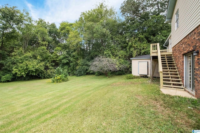 view of yard featuring a storage shed and a wooden deck