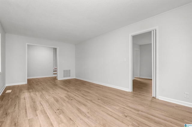 spare room with light hardwood / wood-style flooring