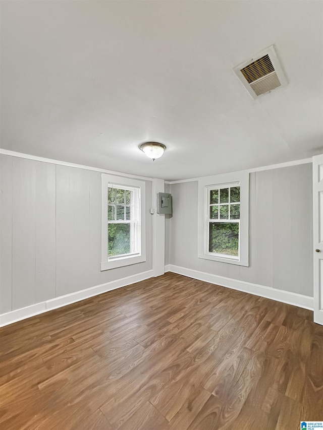 spare room with hardwood / wood-style floors and a healthy amount of sunlight