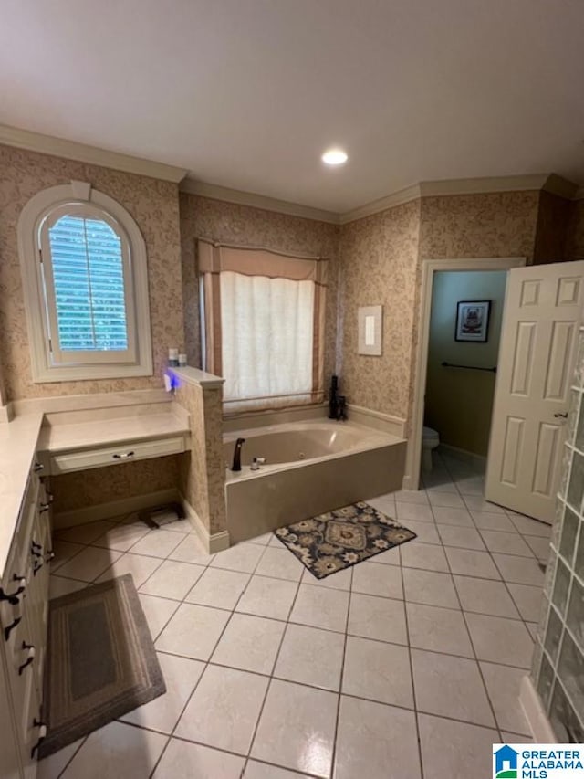 bathroom with vanity, toilet, ornamental molding, a tub to relax in, and tile patterned flooring