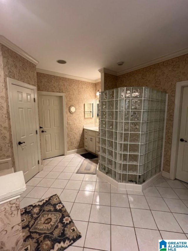 bathroom featuring ornamental molding, tile patterned floors, walk in shower, and vanity