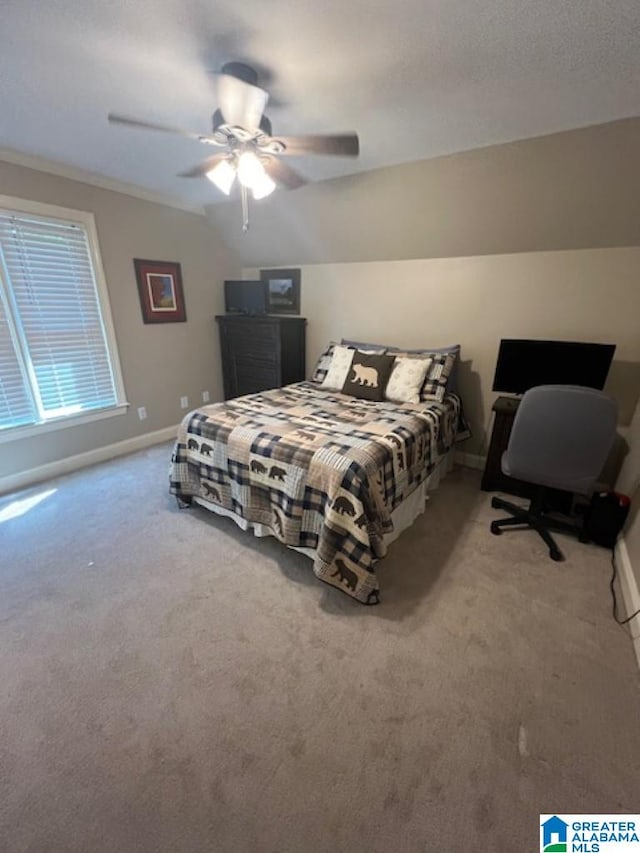 carpeted bedroom featuring ceiling fan and vaulted ceiling