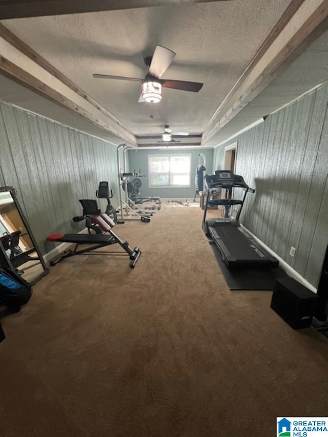 workout area with carpet flooring, a textured ceiling, and ceiling fan