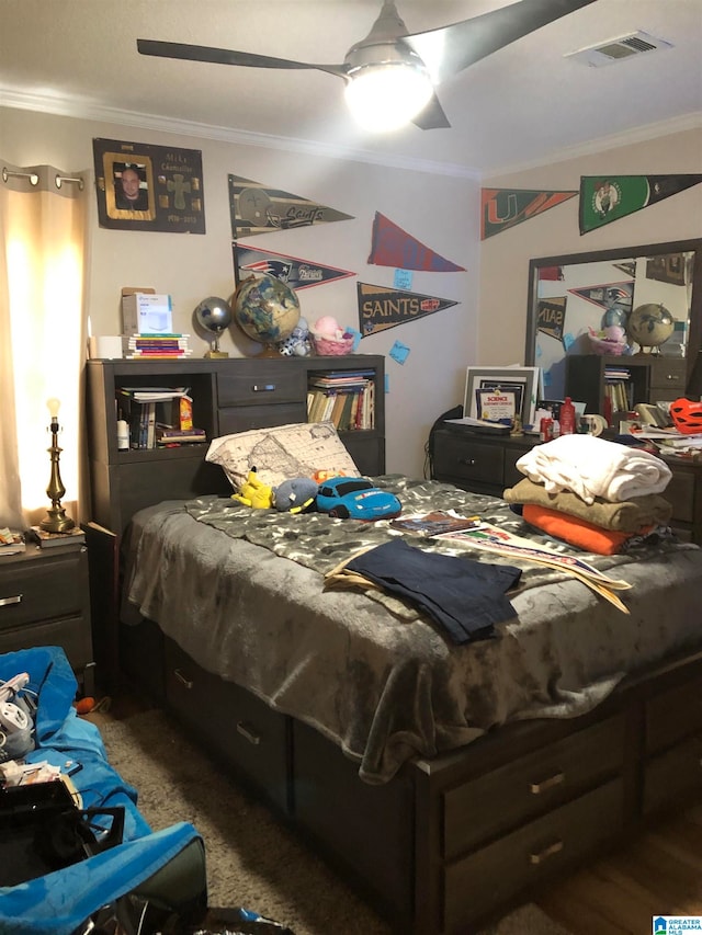 bedroom with ornamental molding, carpet, and ceiling fan