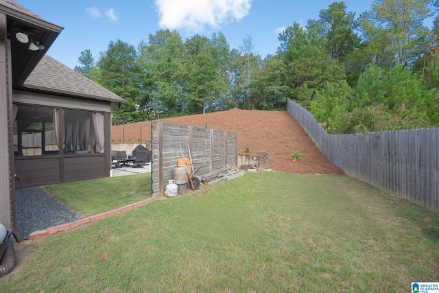 view of yard with a sunroom and a patio