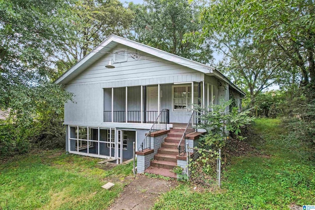 view of front facade with a sunroom